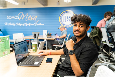 student coding on a laptop
